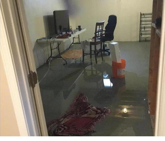 office area with water accumulating on the floor from a heavy rain.
